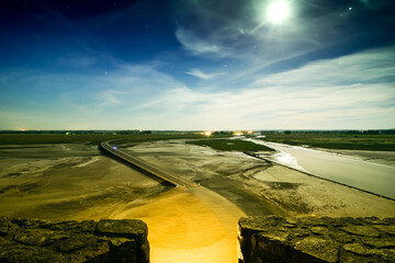 Night sky road and starry sky panorama from Mont saint-michel mount viewpoint. Famous romantic...