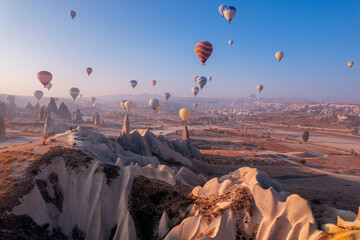 Travel tourist concept, Landscape sunrise with hot air balloons fly over deep canyons, valleys...