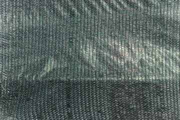 Silvery fabric stitched with black threads. Silver glitter background, white sparkling texture.