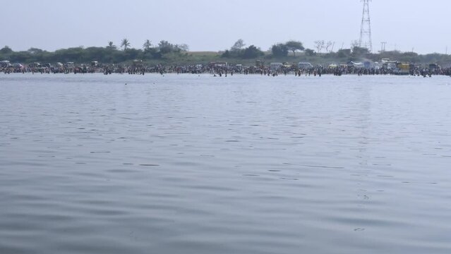 Wide view of large devotees bathing in the huge river during the fair