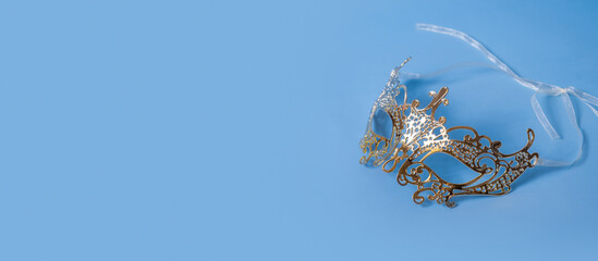 Banner with festive face mask for masquerade or carnival celebration on colored background