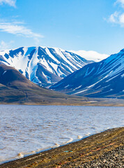 Longyearbyen snow cappped mountains next to bay