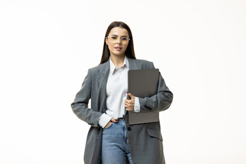 Portrait of a businesswoman holding laptop computer iand looking away solated over white background