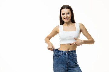 beautiful young woman with big jeans, isolated on white background
