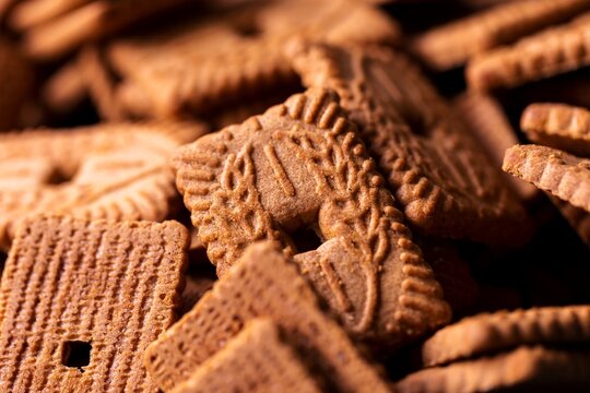 A portrait of a stack of brown cookies called speculaas or speculoos in Belgium or the Netherlands. The spiced biscuit is very delicious and popular during the winter period to be eaten at any time.