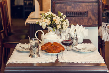 A set table for tea drinking in retro style of USSR times with baked pies.