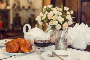A set table for tea drinking in retro style of USSR times with baked pies.