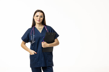 Smiling female doctor in lab coat with arms crossed looking away and posing against grey background. Medicine concept