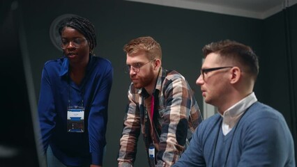 multiethnic team of software designers or data analysts solving problem and discussing project