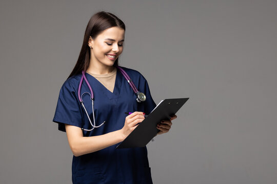 Young Female Medical Assistant With Folder On White Background