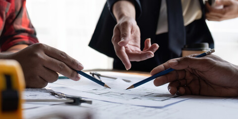 Team engineer man working with laptop and inspection for architectural plan,sketching a...