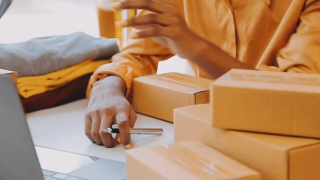 Fashion designer l young asian woman working using laptop, tablet and smiling while standing in workshop Responding on business