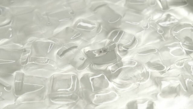 Close up footage of ice cubs melting.