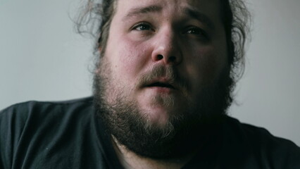 Obraz premium Preoccupied man suffering from mental pain. Close up face of a worried person with anxious expression. Emotional disorder concept