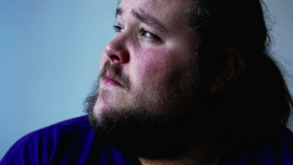Obraz premium One overweight man with preoccupied expression close up face