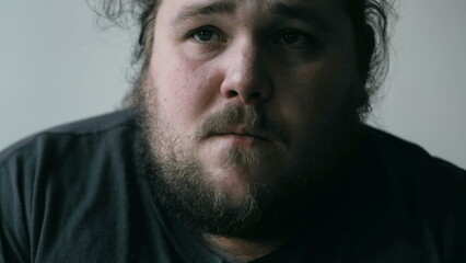 Preoccupied man suffering from mental pain. Close up face of a worried person with anxious expression. Emotional disorder concept