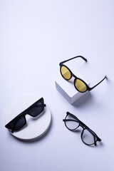 Three variants of glasses and a podium are on a white background.