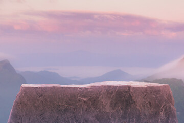 Stone podium table top on with outdoor mountains pastel color scene nature landscape at sunrise blur background.Natural beauty cosmetic or healthy product placement presentation pedestal display.