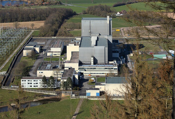 W&uuml;rgassen, Germany - 03 23 2020: Aerial view of the nuclear power plant with office buildings, service buildings and the reactor building surrounded by meadows and trees.