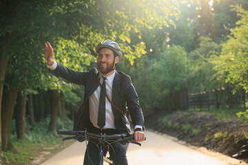 Handsome bearded businessman saying goodbye to workmate after job.