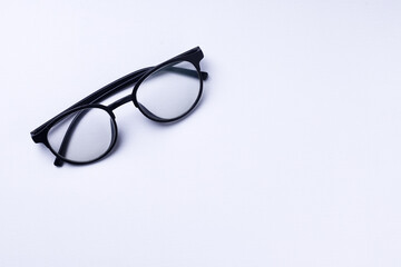 Glasses with transparent lenses are on a white background.