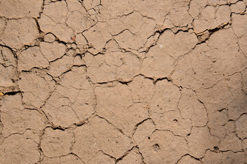 Wall texture soil dry crack pattern of drought lack of water of nature brown old broken background.