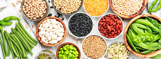 Legumes and beans. Dried, raw and fresh. Lentils, chickpeas, mung beans, soybeans, edamame, peas in glass jars. Healthy diet food, vegan protein, micronutrients and fiber sources. Banner