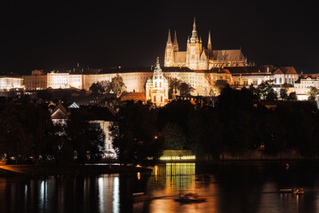 Fototapeta na wymiar Night view of Prague Castle and st. Vitus cathedral over Vltava river