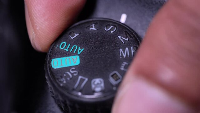 hand dialing modes on vintage camera settings button