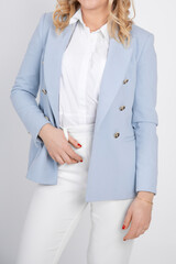 Woman stand in blue blazer, white blouse and trousers, crop photo. Female studio portrait, isolated on white background.