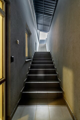 Empty staircase leading up with between modern office buildings.