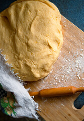 Freshly kneaded homemade dough on a wooden board.
