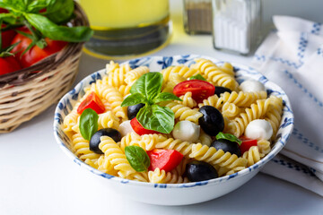 Italian cold pasta salad or Pasta fredda alla caprese. Directly above. Fusilli, tomato, mozzarella, olive, arugula. Turkish name; burgu makarna salatasi