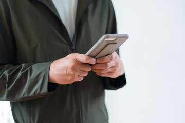Close up of man`s hand holding smart phone research shopping  .