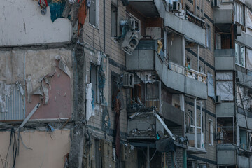 Fototapeta na wymiar Impact on a high-rise building in the city of Dnipro, Ukraine. A residential building destroyed by an explosion after a Russian missile attack. Consequences of the explosion.