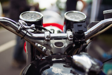 close-up of a speedometer on a motorcycle and steering wheel isolated