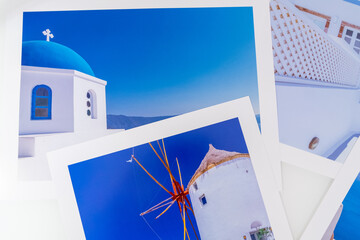 Lot de photos de voyage de différentes vues de Santorin posées sur une table blanche.