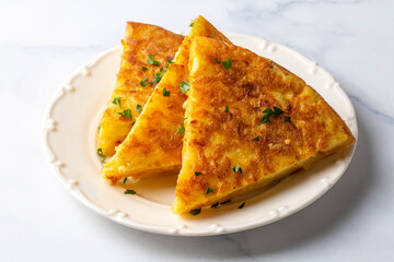 Spanish omelette with potatoes, typical spanish cuisine on gray concrete floor. Tortilla Espanola. Turkish name; Yumurtali patates