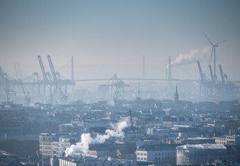 Cold and foggy day in Hamburg, Germany. Picture of the city center, cranes in the harbor and the...