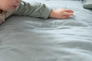 A small child reaches out with his hand for the object. Close up of the child's hand. Background...