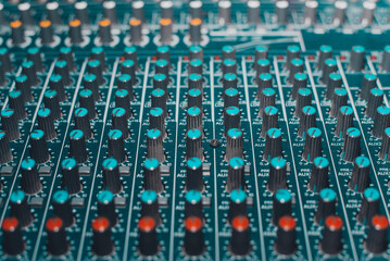 Mixing studio console, equalizer audio controllers close-up, selective focus