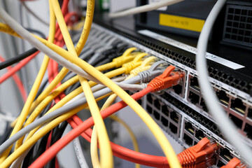 Network technology - multiple colorful cables in an IT and server room