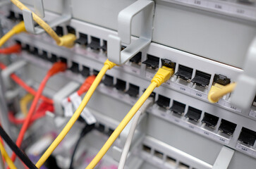 Network technology - multiple colorful cables in an IT and server room