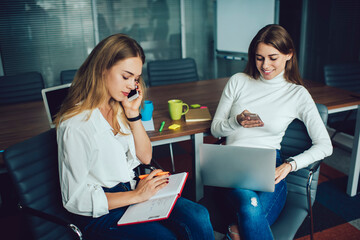 Young women sitting in meeting room and working on project