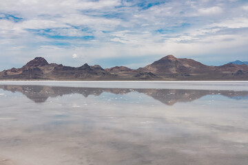 Panoramic view of beautiful mountain reflecting in lake of Bonneville Salt Flats, Wendover, Western Utah, USA, America. Looking at summits of Silver Island Mountains range. West of Great Salt Lake