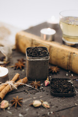 Black tea. Tea time. Photo of a black tea for a restaurant, menu or a website. Black tea with spices. Tea cup on the book.