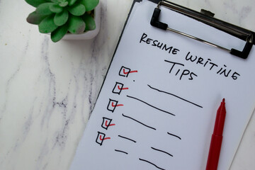 Concept of Resume Writing Tips write on paperwork isolated on Wooden Table.