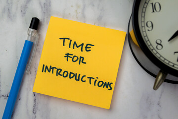 Concept of Time for Introductions write on sticky notes isolated on Wooden Table.