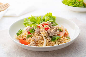 instant noodle spicy salad.Thai hot and sour noodle salad with minced pork that is very flavorful and addictive