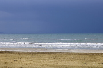 View of Mediterranean Sea with a cloudy blue sky after the rain. Waves and wind in Larnaca beach